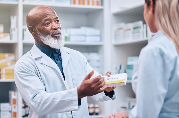 Healthcare, pharmacist and man at counter, medicine, prescription drugs and happy service at drug store. Health, wellness and medical insurance, black man and woman at pharmacy for advice and pills