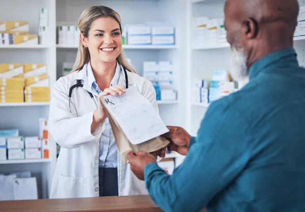 Pharmacy, happy pharmacist and customer with medicine or prescription pills helping with medical healthcare. Retail, shopping or doctor giving senior black man advice, medication or drugs in store.