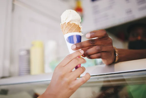 Hands, ice cream and woman buying icecream cone at a shop, local and small business support. Sugar, dessert and person purchase snack from seller to enjoy on summer day as a frozen sweet in the city.