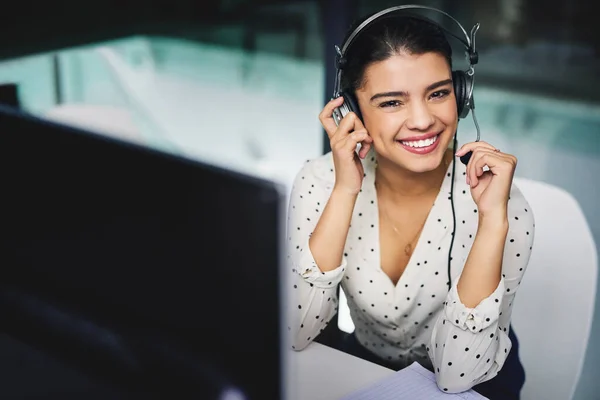 Im here to help. Cropped portrait of an attractive young businesswoman working late in a call center