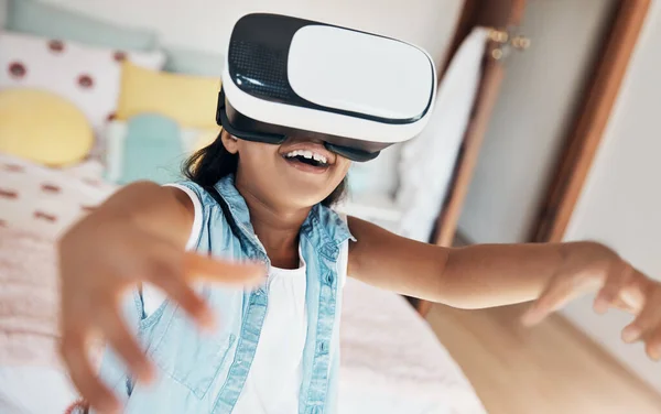 The future of fun is now. a young girl using a virtual reality headset at home