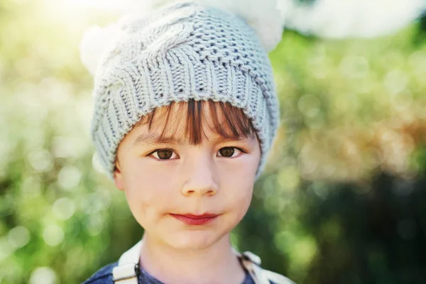 What a cute little guy. Portrait of an adorable little boy playing outside