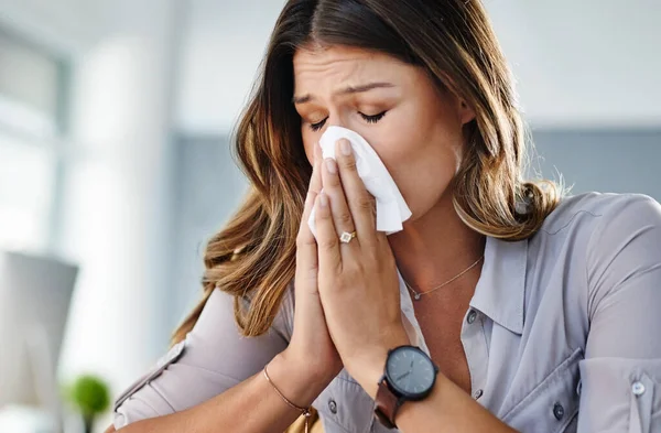 How can anyone work like this. a businesswoman working in her office while suffering from allergies