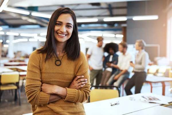 I have full confidence in my team and their ability. Cropped portrait of an attractive young businesswoman in the office with his colleagues in the background