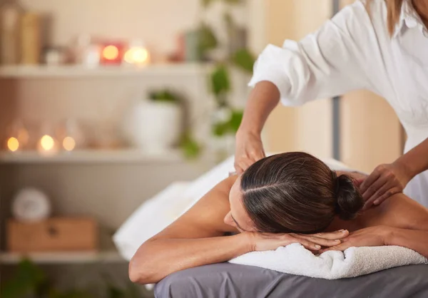Massage, relax and peace with woman in spa for healing, health and zen treatment. Detox, skincare and beauty with hands of massage therapist on customer for calm, physical therapy or luxury in salon.