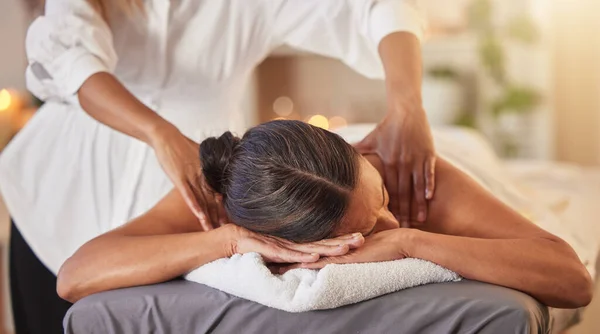 Woman at spa for massage with therapist and holistic treatment, wellness and self care with aromatherapy. Luxury service, health and peace with skincare to relax at salon, masseuse hands for zen