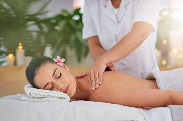 Time for some well-deserved pampering. an attractive young woman enjoying a back massage at a spa