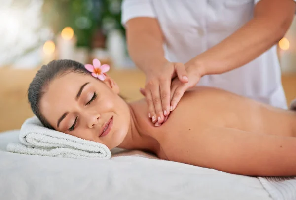 Theres magic to even just a simple massage. an attractive young woman enjoying a back massage at a spa