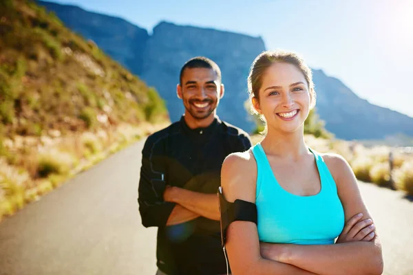 Youll feel healthier plus happier after a great workout. Portrait of a sporty young couple standing outside together