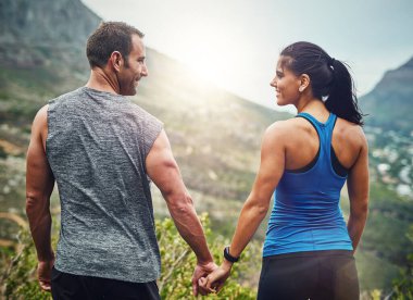 Going out there together and getting fit. a young attractive couple training for a marathon outdoors clipart