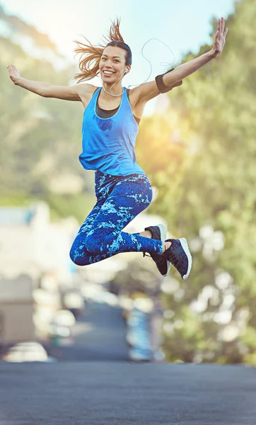 Proving yourself wrong never felt so good. a young woman jumping in mid air after her workout