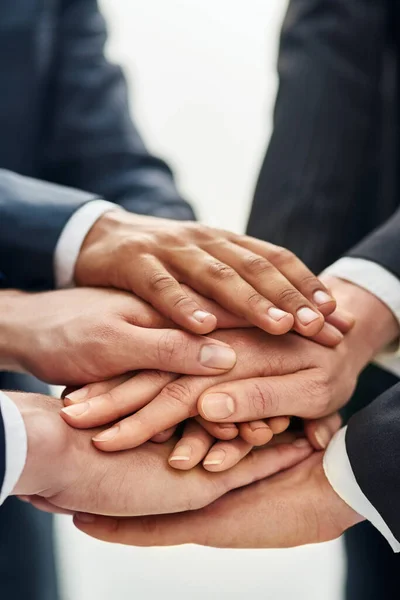Collaboration is this teams secret to success. Closeup shot of a group of businesspeople standing in a huddle with their hands stacked together