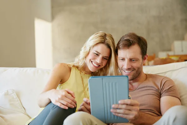 This is what weekends are made of. a happy couple using a digital tablet together on a relaxing day at home