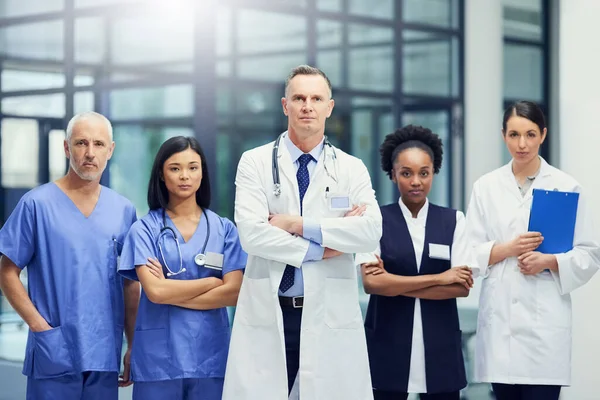 Experience you can count on. Portrait of a group of focused medical professionals standing in a hospital corridor