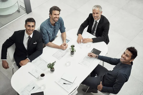 Our team has everything covered. High angle portrait of a group of businessmen having a meeting around a table in an office
