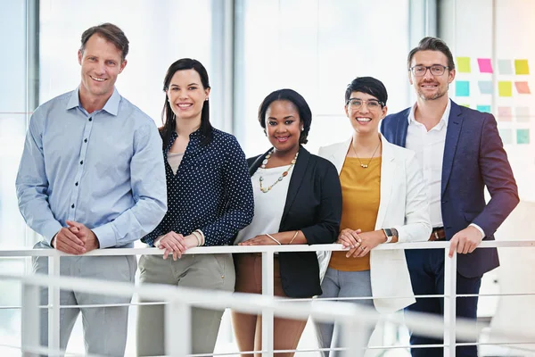 Were the team you need if you wish to succeed. Cropped portrait of five business colleagues standing in the office