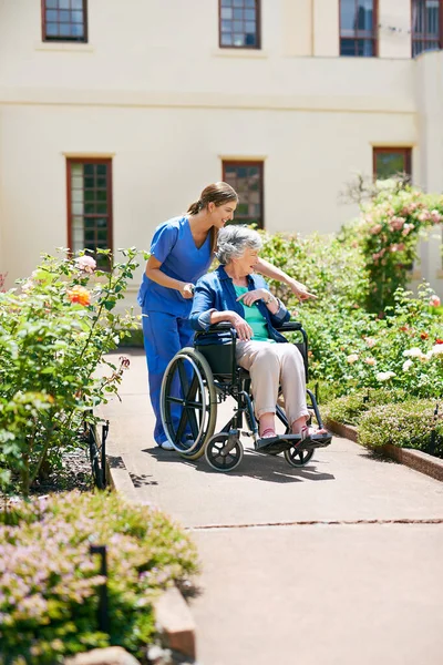 Can you name that one. a resident and a nurse outside in the retirement home garden