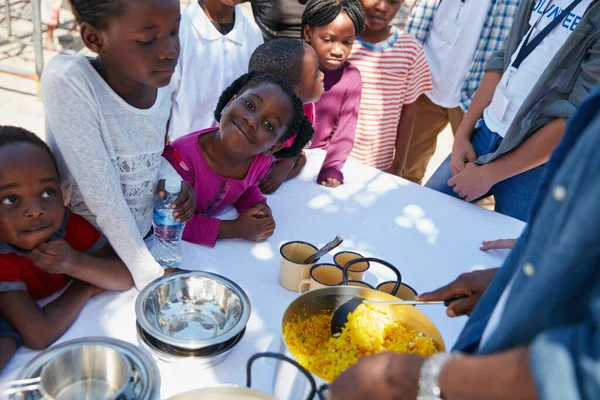 stock image Im either happy or hungry. Cropped portrait of children getting fed at a food outreach