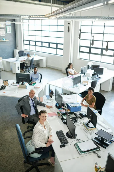 This is where the companys success starts. Portrait of a group of coworkers sitting at their workstations in an office