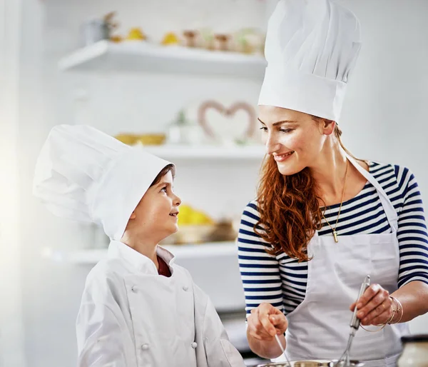 Mom, you inspire me. a mother and her son baking in the kitchen
