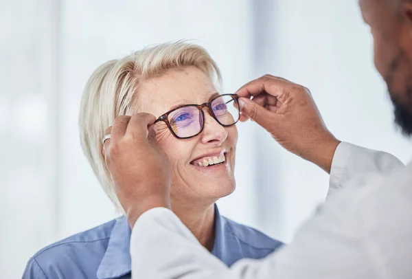 Vision, glasses with doctor and patient, eyes health and optometry, senior woman with black man at clinic. Eye exam, ophthalmology and health insurance with happy customer, consultation and glaucoma