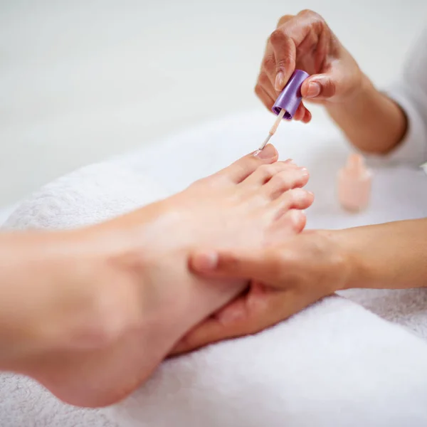 Put your best foot forward. Closeup shot of a woman getting a pedicure in a health spa