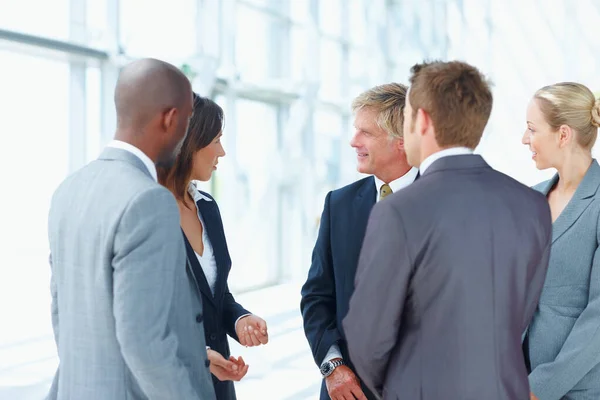 Multi racial executives discussing in office. Portrait of multi racial business executives discussing in office