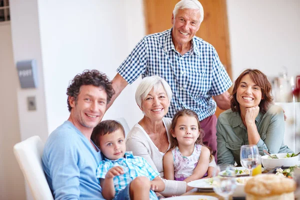 Good food brings families together. a multi-generational family having a meal together