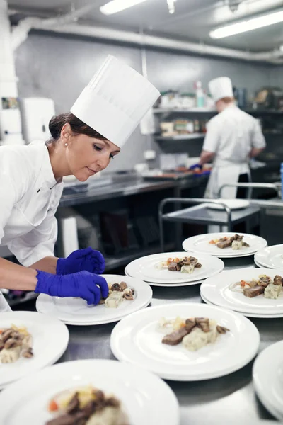 Plating up culinary art. a chef plating food for a meal service in a professional kitchen