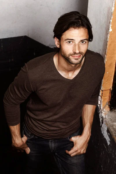 stock image Rustic and rugged. Portrait of a handsome young man with his hands in his pockets