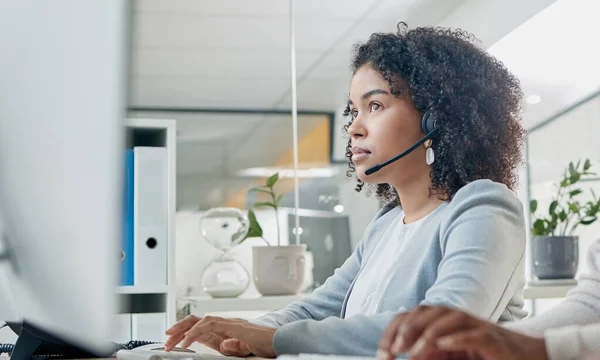 Crm, contact us or black woman in call center at customer services for a communication or telemarketing agency. Computer, microphone or African consultant talking, helping or speaking at office desk.