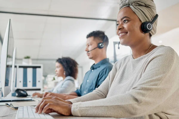Black woman, call center consultant and contact us with CRM and happy employee at desk with keyboard and computer. Communication in customer service or telemarketing with tech support and online