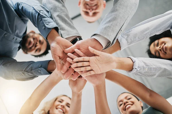 Team building, hands or happy business people with support, mission or goals for success in office building. Low angle, meeting or employees in partnership working with hope, team work or motivation.