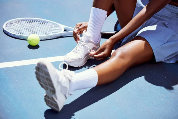 Tennis player woman, shoelace and ready for game, training or exercise sneakers in development, sports or focus. Sport expert, girl athlete and professional shoes with tennis ball, racket and goals.