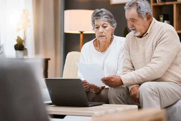 Laptop, documents and retirement with a senior couple planning their savings or investment portfolio. Budget, finance and pension with a mature man and woman working on a computer together in a home.