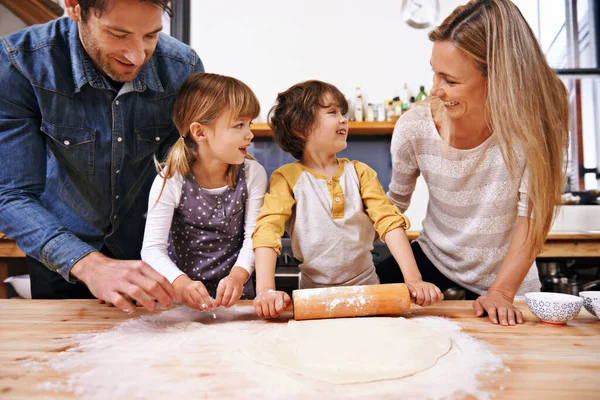 Am I doing it right mom. A family making pizza together at home
