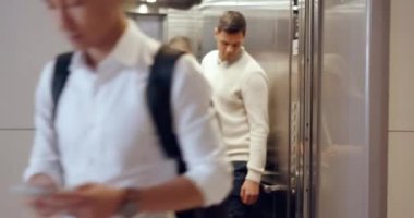 Elevator, travel and airport with business people holding luggage for a global or international trip. Exit, door and hotel with a busy employee group ready to leave in a terminal or departure lounge.