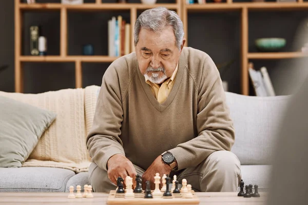 Senior man, thinking or playing chess in house, home living room or apartment in Japanese strategy, checkmate or board game contest. Retirement elderly, smart person or chessboard challenge for mind.