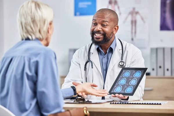 Doctor, patient and black man with tablet, brain scan or results for disease, explain procedure or healthcare. Medical professional, senior female or woman in office, cure or conversation for surgery.
