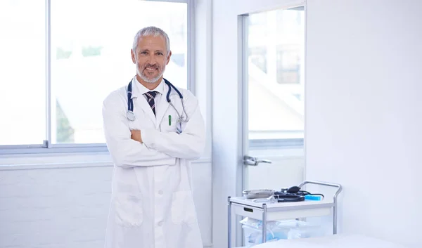 Ready for any emergency. Portrait of a doctor standing in a well-lit room