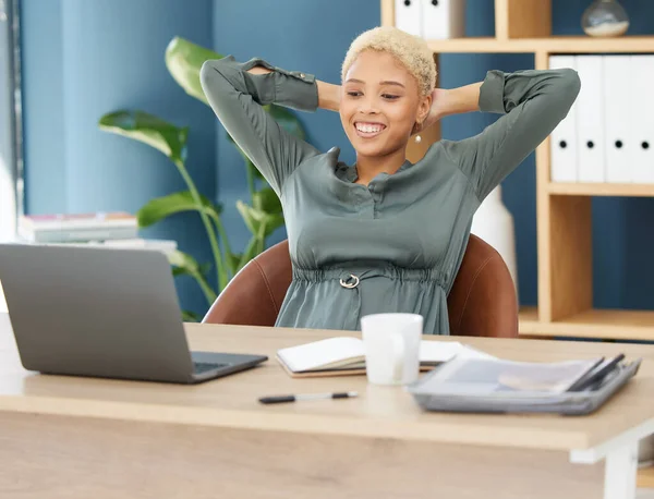 Stretching at office desk, calm black woman smiling at work laptop and business in New York company. Confident lawyer reading email, relax in professional workplace and happy in corporate success.