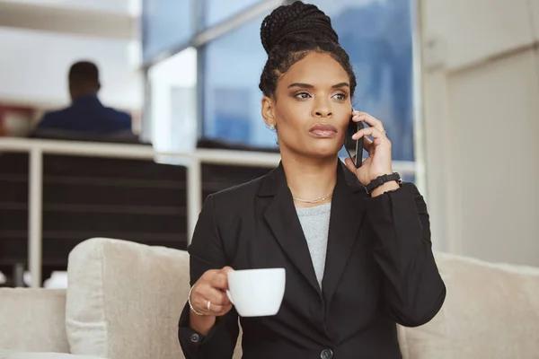 Coffee, phone call or business black woman in b2b networking in office sofa for sales deal or marketing. Corporate, focus or employee for communication mobile tech in planning, innovation or strategy.