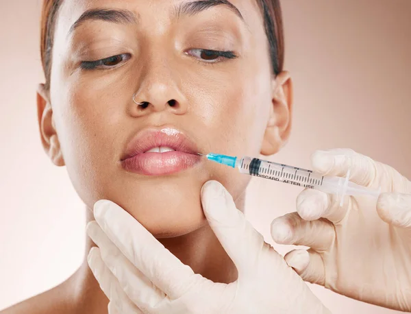 Botox, face and beauty with woman and lip filler, plastic surgery zoom and syringe needle for procedure. Hands, serum and cosmetic care for lips, facial injection treatment against studio background.