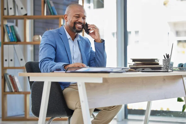Phone call, business and black man at office desk for corporate communication in company. Mature entrepreneur, mobile networking and talking on smartphone for sales deal, negotiation and ceo contact.
