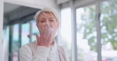 Business, senior woman and blowing kiss in office, celebration and happiness for corporate deal, brand development and goal. Mature female, Canada and ceo with company success, achievement and target.