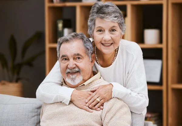Love, portrait or old couple hug in house living room enjoying quality bonding time in happy marriage commitment. Trust, support or elderly woman in romantic partnership with an old man in retirement.