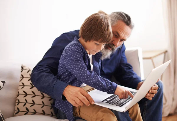 Me and grandpa working on the laptop. a grandfather and grandson using a laptop together