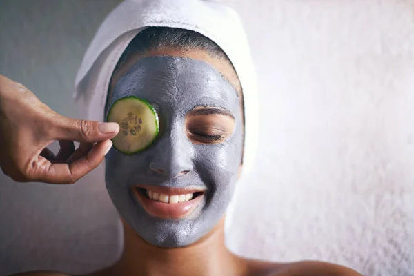 Feels heavenly... my skins going to thank me. a young woman enjoying a facial treatment at a spa