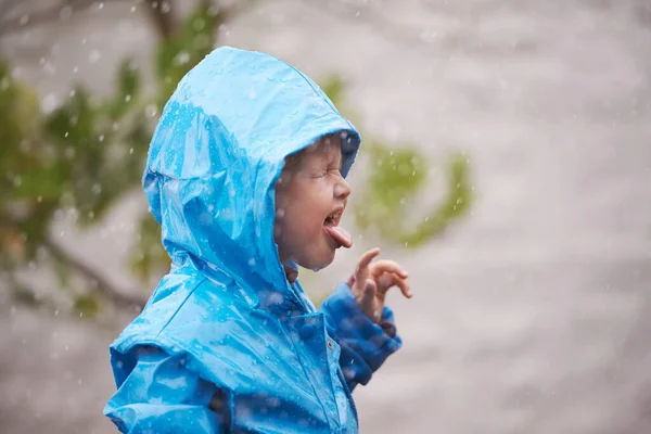 Fun and games in the rain. an adorable little girl playing outside in the rain