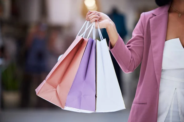 Shopping bag, customer and hands of a women holding paper bag in a mall for retail, therapy, sale and discount. Fashion female holding purchase of clothes or gift on discount or promotion at a store.